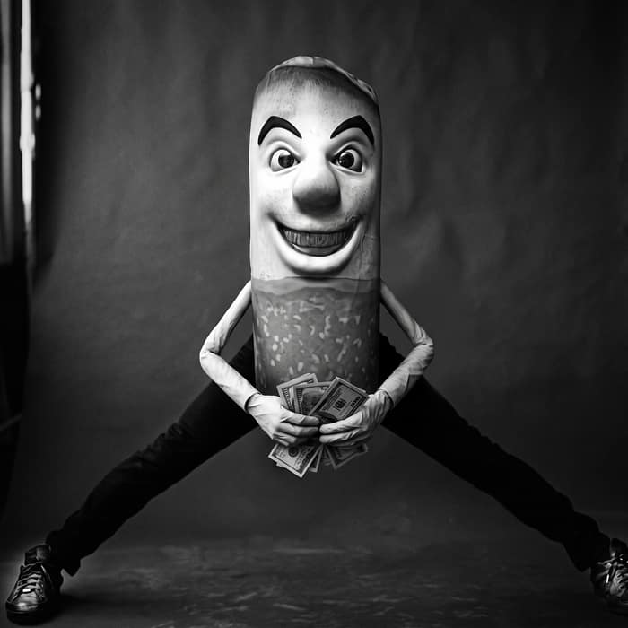 The mascot leaping in a mid-air jump split, clutching a fistful of hundred dollar bills.